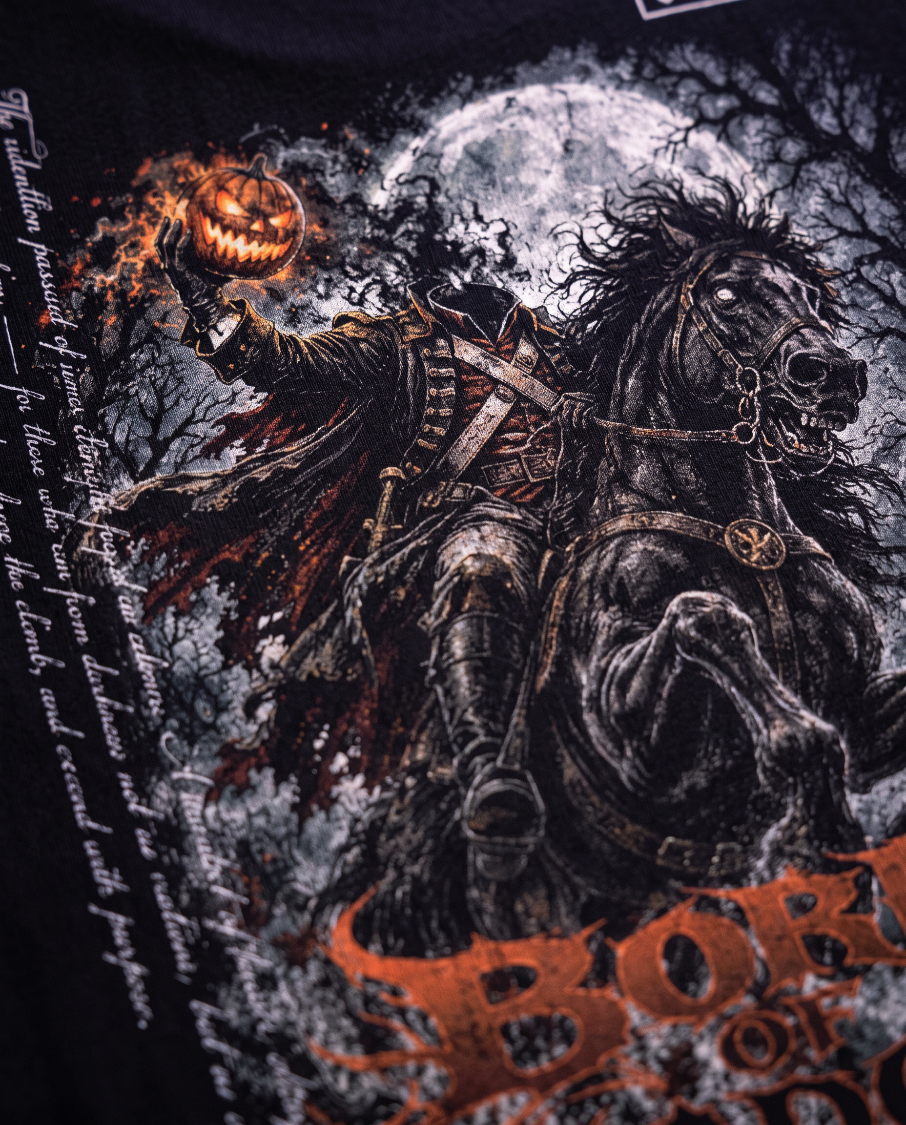 Close-up of a Born of Shadows back print on black cotton
